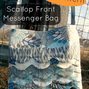 May include: A Scallop Front Messenger Bag with a floral pattern in shades of blue, grey, and cream. The bag features a scalloped front design and the text "PDF Pattern". The bag is hanging on a wooden post.