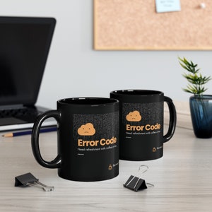 May include: Two black coffee mugs with a white cloud and the text "Error Code" in orange. The text below the cloud reads "Need refreshment with coffee or tea..."