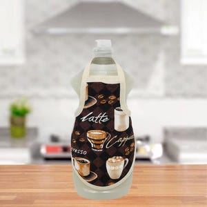May include: A clear bottle with a white cap, adorned with a brown apron-shaped cover. The apron features coffee-themed graphics, including coffee cups, beans, and the words "Latte," "Cappuccino," and "Espresso."