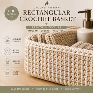 May include: A rectangular crochet basket with a thick, beige yarn texture. The image includes text: CROCHET PATTERN RECTANGULAR CROCHET BASKET, BEAUTIFUL TEXTURE, MODERN, STURDY, PRACTICAL, BEGINNER FRIENDLY, NO SEW DESIGN, EASY TO FOLLOW, STEP-BY-STEP GUIDE, VIDEO SUPPORT.