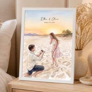 May include: A framed watercolour print depicting a beach proposal scene with a person kneeling to offer a ring to another person. The text "Ethan & Olivia" and "August 16, 2026" is printed at the top against a sunset sky background.