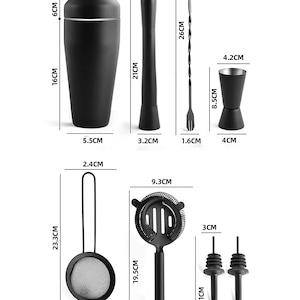 May include: A black cocktail shaker (16cm tall, 8.3cm wide), muddler (21cm), bar spoon (26cm), jigger (8.5cm), strainer (23.3cm), Hawthorne strainer (19.5cm), and two pour spouts (11cm). All items are black.
