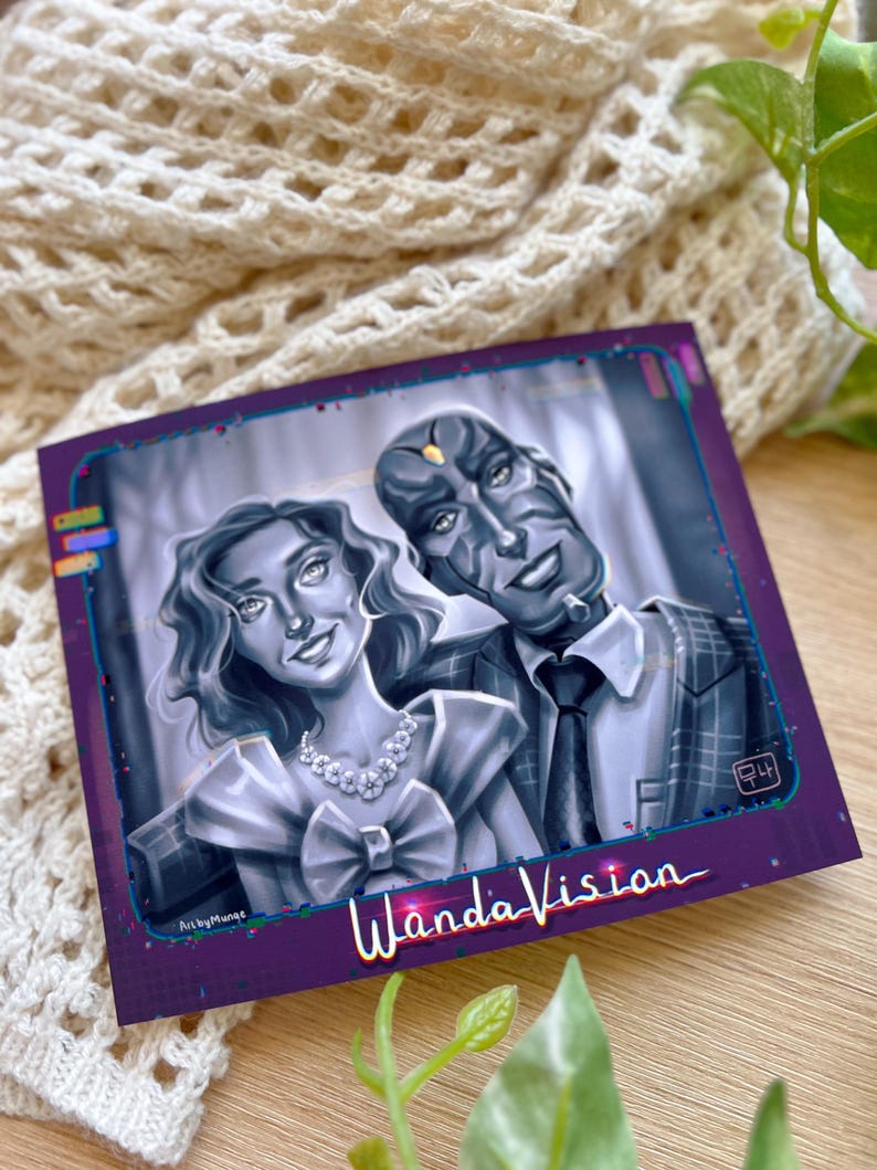 May include: A square print featuring a grayscale illustration of two characters from WandaVision. The woman wears a dress with a large bow and a necklace. The man is in a suit and tie. The print has a purple border with the show's title.
