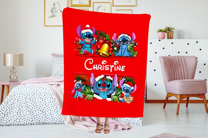 May include: A red Christmas blanket featuring Stitch from Lilo & Stitch. The blanket has multiple images of Stitch wearing a Santa hat and holding Christmas decorations. The name "Christine" is written in white script.