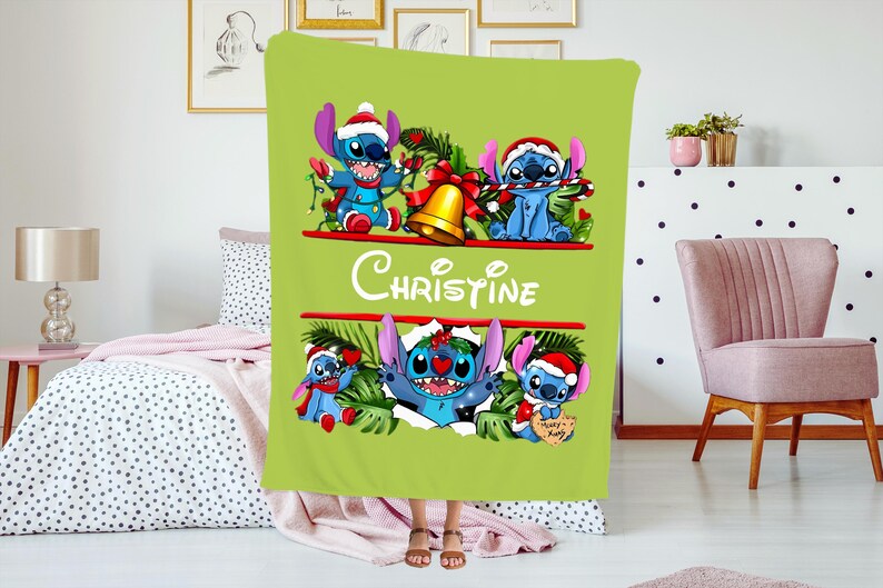 May include: A lime green blanket featuring the character Stitch from Lilo & Stitch in a Christmas theme. The blanket has the name "Christine" in white script. Stitch is wearing a Santa hat and holding candy canes.