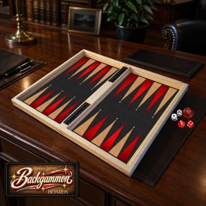 May include: A wooden backgammon board featuring a black playing surface with alternating red and light wood triangular points. The set includes two white dice and two red dice, one of which is marked with the number 16. The board is open.