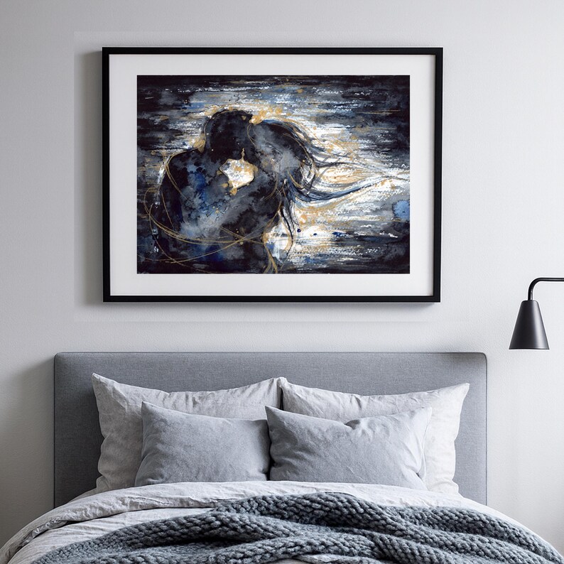 Op de afbeelding: Een ingelijste kunstdruk met een abstract schilderij van twee figuren in een nauwe omhelzing. Het kunstwerk gebruikt een kleurenpalet van donker marineblauw en zwart met contrasterende gouden verfstreken en accenten voor beweging.