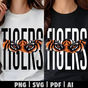Op de afbeelding: Een wit t-shirt en een zwart t-shirt, elk met het woord TIGERS in grote hoofdletters en een afbeelding van intense, oranje en zwarte tijgerogen horizontaal in het midden van de tekst. Onderaan staat de tekst PNG | SVG | PDF | AI.