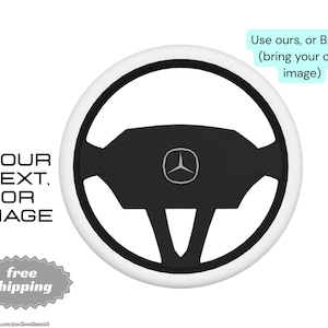 May include: A black and white steering wheel with a Mercedes-Benz logo in the center. The wheel has a white outer ring and black inner spokes. Text on the left says "YOUR TEXT OR IMAGE". Text on the top right says "Use ours, or B.Y.O.I. (bring your own image)".