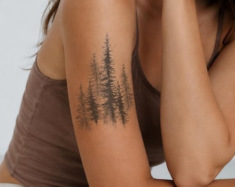 May include: A temporary tattoo design featuring a cluster of dark brown pine trees with detailed needle textures and a stippled base effect. The artwork is applied to the upper arm, showcasing a dense forest scene with varying tree heights.
