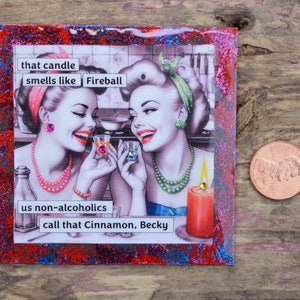 Pode incluir: Uma ilustra&ccedil;&atilde;o de estilo vintage de duas mulheres com uma legenda que diz "that candle smells like Fireball us non-alcoholics call that Cinnamon, Becky". A imagem est&aacute; sobre um fundo de glitter vermelho, azul e prateado.