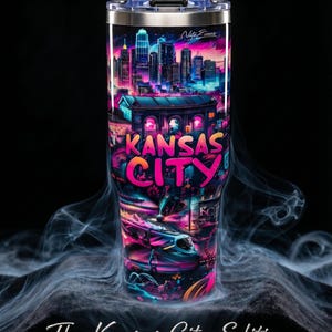 May include: A stainless steel tumbler with a vibrant, neon-colored Kansas City design. The artwork features the city skyline, a train, and the words "Kansas City" in bold letters. The tumbler is part of the Collector's Series.