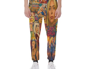 May include: Multi-colored sweatpants featuring a collage of images of Lady Gaga. The design includes various portraits and performance shots of the singer, with the words "LADY GAGA" prominently displayed. The pants have a drawstring waist and black cuffs.