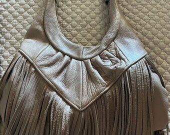 Taupe leather designer cut bag with fringe