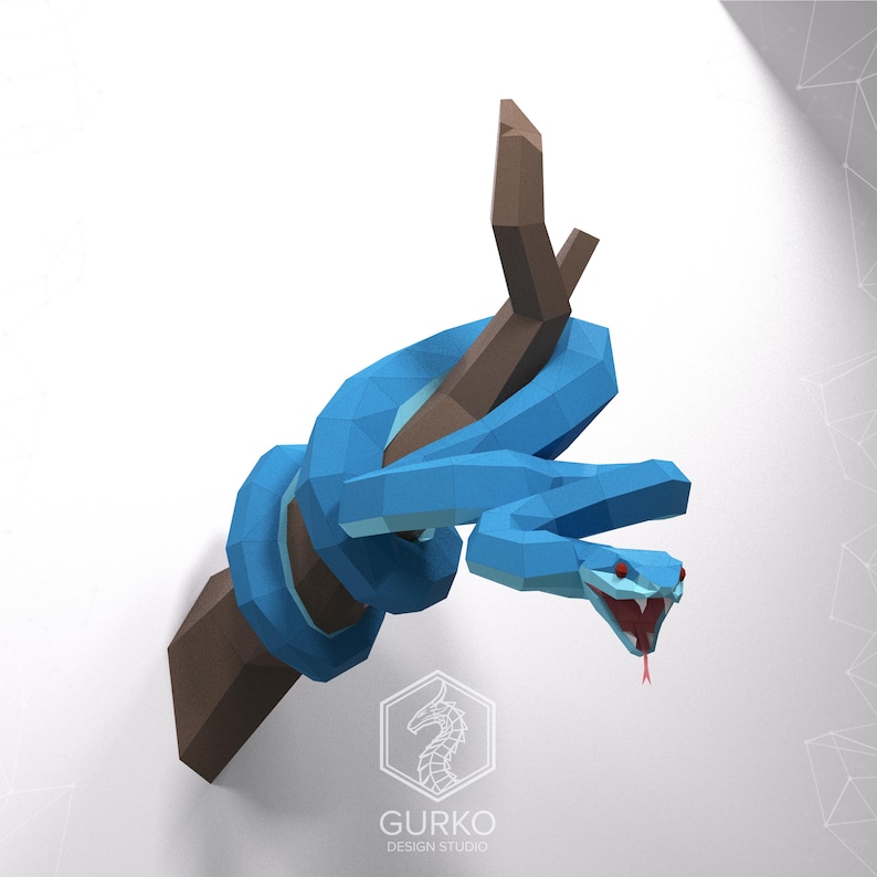 May include: A blue papercraft snake wrapped around a brown branch. The snake has red eyes and an open mouth. The snake is a 3D paper model.