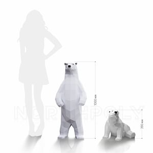 May include: Two white polar bear sculptures made of paper. The larger bear is standing and measures 39.4 inches tall. The smaller bear is sitting and measures 15.4 inches tall.