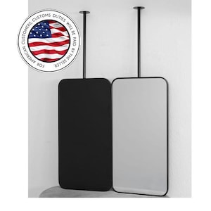 Pode incluir: Dois espelhos retangulares suspensos. Um é preto, o outro é refletivo. Ambos têm uma moldura preta fina e são suspensos do teto por uma haste preta. O texto na imagem diz "FOR AMERICAN CUSTOMERS DUTIES WILL BE PAID BY THE SELLER."