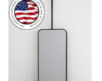 May include: A rectangular mirror with rounded corners, framed in black, suspended from a black rod attached to the ceiling. The mirror is displayed against a white wall. The text "FOR AMERICAN CUSTOMERS, CUSTOMS DUTIES WILL BE PAID BY THE SELLER" is in a circle.