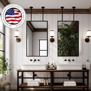 May include: A modern bathroom with two sinks, mirrors, and sconces. The sinks are set on a dark wood and black metal vanity. The mirrors are rectangular with black frames. The walls are white with vertical paneling. The image includes the text: "FOR AMERICAN CUSTOMERS. CUSTOMS DUTIES WILL BE PAID BY THE SELLER."