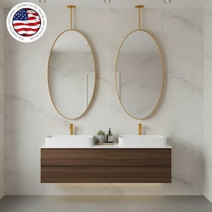 May include: A modern bathroom vanity set featuring two oval gold-framed mirrors suspended above a floating dark wood cabinet with four drawers. The set includes two white rectangular sinks with gold faucets, a small plant, and a soap dispenser.