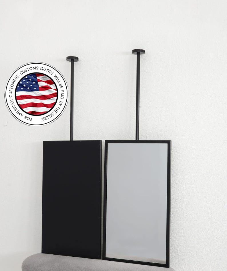May include: Two rectangular, black framed mirrors suspended from the ceiling. One mirror is black, the other is reflective. The mirrors hang from black rods. A circular graphic with the American flag and text that reads "For American Customers, Customs Duties Will Be Paid By The Seller" is in the image.
