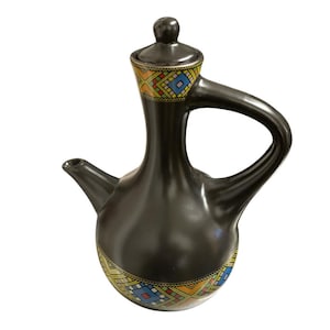 May include: A black ceramic coffee pot with a long neck, a curved handle, and a matching lid. The base and the neck feature a decorative band with a geometric pattern in yellow, red, blue, and green colors against a black background.
