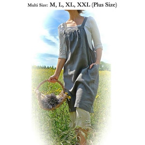 May include: A gray smock frock sewing pattern, with a woman wearing the smock in a field of flowers. The pattern is available in sizes M, L, XL, and XXL. The text on the image reads "Easy Smock Frock (Easy Fit Pinafore) Downloadable Sewing Pattern by Verity Hope Multi Size: M, L, XL, XXL (Plus Size) Loose Fitting & Easy To Make www.VerityHope.com"