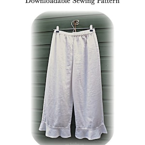 May include: White linen pants with a ruffled hem, hanging on a hanger against a green wooden background. The pants have a wide leg and a relaxed fit. The text "PANTALOONS Downloadable Sewing Pattern" is at the top of the image. The text "www.VerityHope.com" is at the bottom of the image.