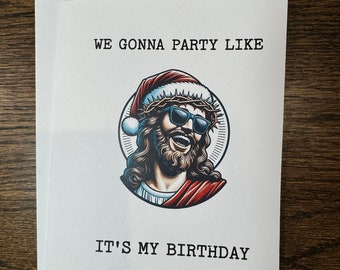 Könnte beinhalten: Eine weiße Karte mit dem Text "WE GONNA PARTY LIKE IT'S MY BIRTHDAY" in schwarzer Schrift. In der Mitte der Karte befindet sich ein Cartoon-Bild von Jesus mit einem Weihnachtsmann-Hut und Sonnenbrille.