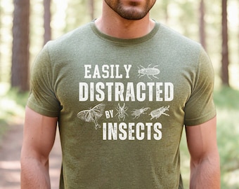 May include: A green t-shirt with the text "Easily Distracted by Insects" in white. The text is surrounded by images of insects, including a moth, a beetle, and a stag beetle.