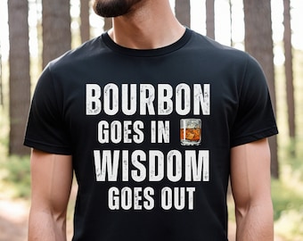 May include: Black t-shirt with white text that reads "Bourbon goes in Wisdom goes out" and a graphic of a glass of bourbon with ice.