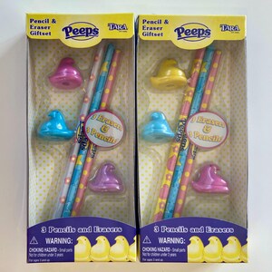 May include: Two boxed pencil and eraser gift sets. Each set contains three pencils and three erasers in the shape of Peeps chicks. The pencils are decorated with pink, blue, and yellow stripes. The packaging includes the text "Peeps" and "3 Pencils and Erasers".