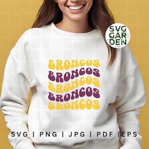 May include: A white sweatshirt with a design of the word "BRONCOS" repeated five times in a retro, wavy font. The word is in alternating colors of yellow and purple.