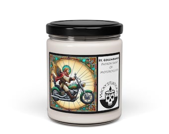 May include: A white candle jar with a black lid features a colorful illustration of a saint riding a green motorcycle. The label reads "St. Columbanus, Patron Saint of Motorcyclists" and includes a skull logo.