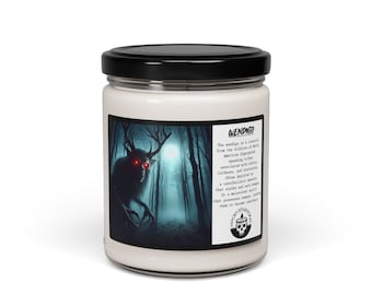 May include: A white candle jar with a black lid. The front label features a dark, shadowy image of a creature with antlers and glowing red eyes in a forest setting. The text on the label reads "WENDIGO" and describes the creature as a cannibalistic spirit from Native American folklore.