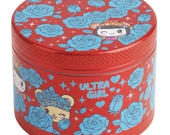 May include: A cylindrical red metal grinder featuring a repeating pattern of light blue roses, small stars, and hearts. The design includes a cartoon character with a flower crown and the text ULTRA GIRL printed in light blue on the side surface.