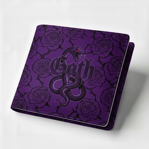 May include: A purple notebook featuring a snake and rose design. The word "Goth" is written in a gothic font. The snake has red eyes and is coiled around the word. The background is a pattern of roses.
