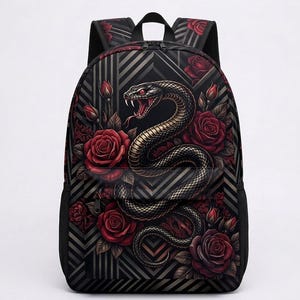 May include: A black backpack featuring a graphic print of a coiled snake with red eyes and an open mouth, surrounded by deep red roses and buds. The background consists of a geometric pattern of dark grey and black chevrons and vertical lines.
