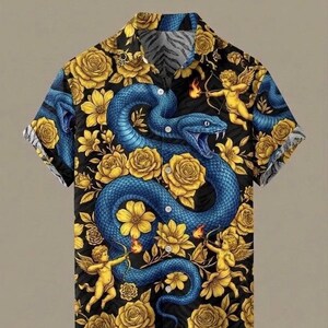 May include: Short-sleeved button-up shirt with a striking design. The shirt features a large blue snake intertwined with yellow roses and cherubs on a black background. The collar and sleeves have a contrasting pattern.