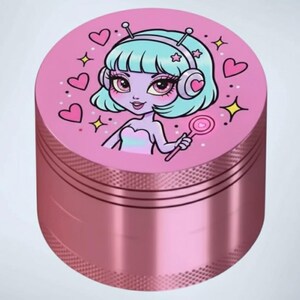 May include: A pink metal grinder with a cartoon alien girl design. The top features a light blue-haired alien with pink hearts, stars, and a lollipop. The grinder has a textured, metallic finish.