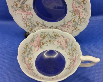 retro tea cup and saucer made by Royal Stafford England 1950s  light blue background with dark blue center and pink flowers gold gilding