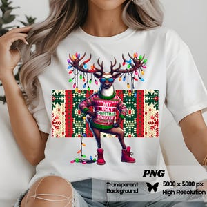 May include: White t-shirt with a graphic of a reindeer wearing a red and green sweater with the text "My Ugly Christmas Sweater". The reindeer is wearing sunglasses and has Christmas lights strung around its antlers.
