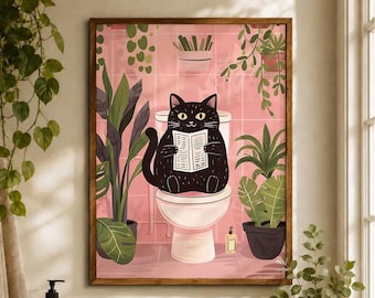 May include: A framed wall art print featuring a black cat sitting on a white toilet in a pink tiled bathroom. The cat is holding an open book. Several green potted plants are arranged around the toilet, and a small bottle sits on the floor.