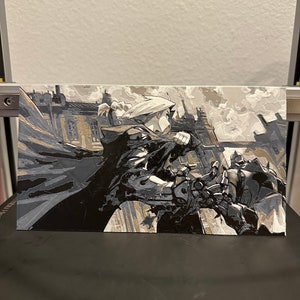 May include: A black and white illustration of a character in a hooded cloak and a robotic arm, fighting another character in a similar cloak. The background is a cityscape with buildings and smoke.