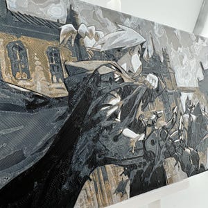 May include: A black and white 3D printed artwork of a character from a manga or anime series. The character is depicted in a dynamic pose, with a dramatic background of a city skyline. The artwork is mounted on a white easel.