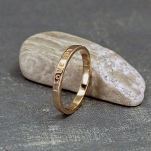 2mm gold ring with custom inscription. The ring has a smooth shiny finish.