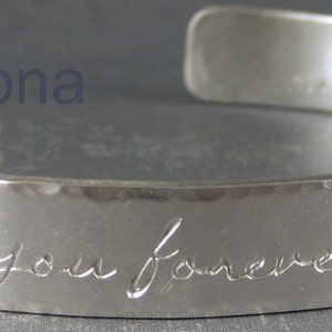 Personalized silver cuff bracelet shown with the Fiona letter style.