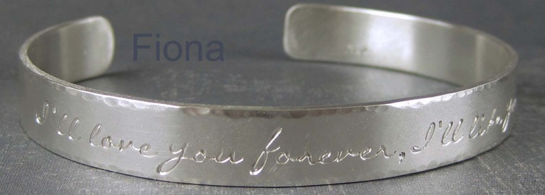 Personalized silver cuff bracelet shown with the Fiona letter style.