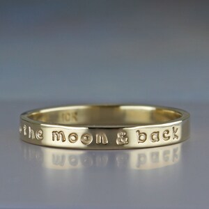 3mm wide gold band with custom inscription.