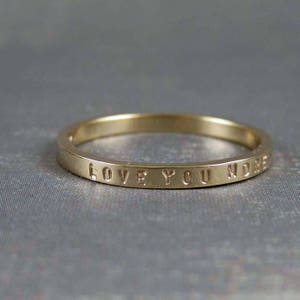 Personalized gold ring. This ring shows an example with the inscription Love you More.